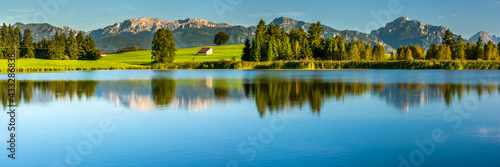 panoramic landscape with alps mountain range at springtime photo