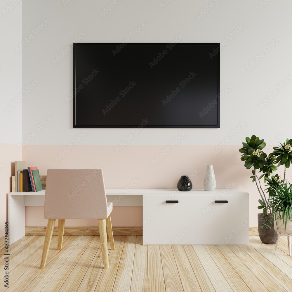 TV on the white and cream wall in the living room with books and vases on the table and the armchairs and trees on the wooden floor.3d rendering. TV on the white and cream wall in the living room with books and vases on the table and the armchairs and trees on the wooden floor.3d rendering.
