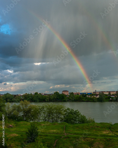 clouds, rain and rainbow over the Kuban river near the city of Krasnodar on a spring rainy day