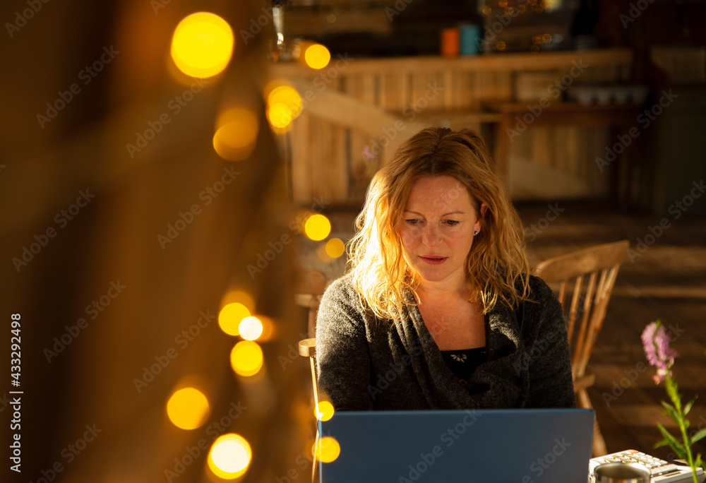 Focused businesswoman working at laptop in cafe Focused businesswoman working at laptop in cafe