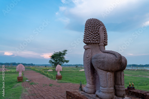 ancient lion statue at temple looking on blue sky. photo