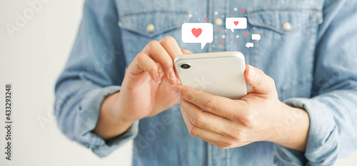 close up young man holding smartphone to chat message with online people in  dating website application to make appointments to flirting for lifestyle people concept