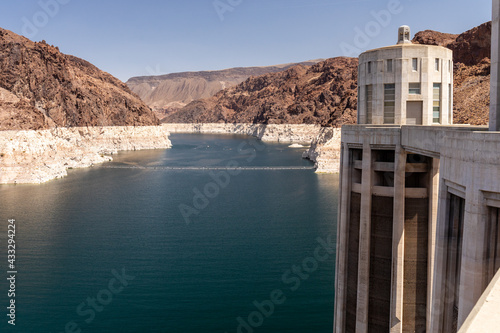 Lighter rock shows the pervious water level of Lake Mead near the intake towers of Hoover Dam
