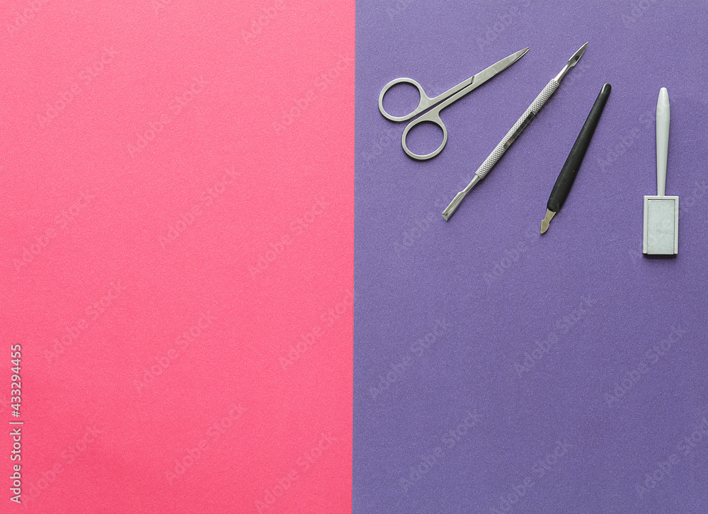 manicure set for shellac with cotton swabs and pads on a pink purple background close up manicure set for shellac with cotton swabs and pads on a pink purple background close up