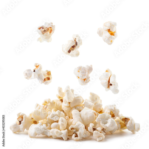Popcorn falls on a heap on a white background. Isolated