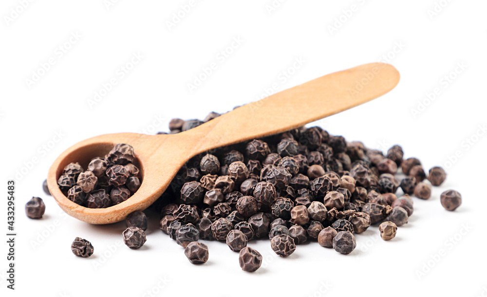 Black peppercorns in a wooden spoon on a white background. Isolated Black peppercorns in a wooden spoon on a white background. Isolated