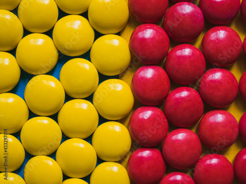 Top view of yellow and red chocolate candies.  Colorful background photo