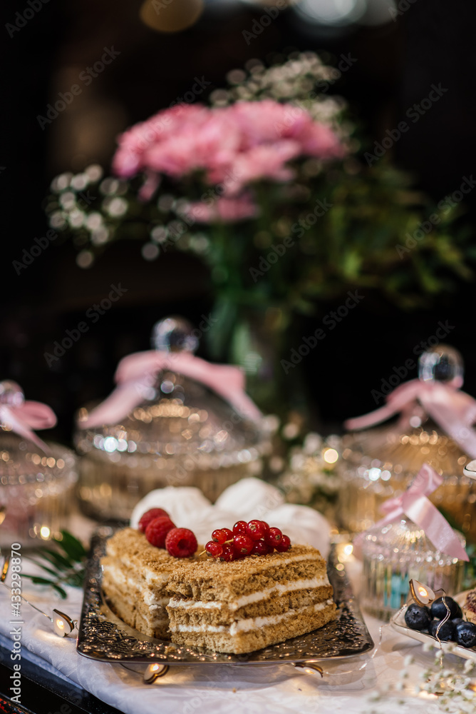 cakes on a silver tray. out of focus background