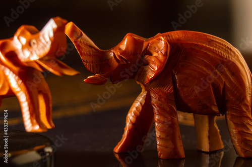 Photography A wooden elephant miniature art with its raised trunk,African crafts