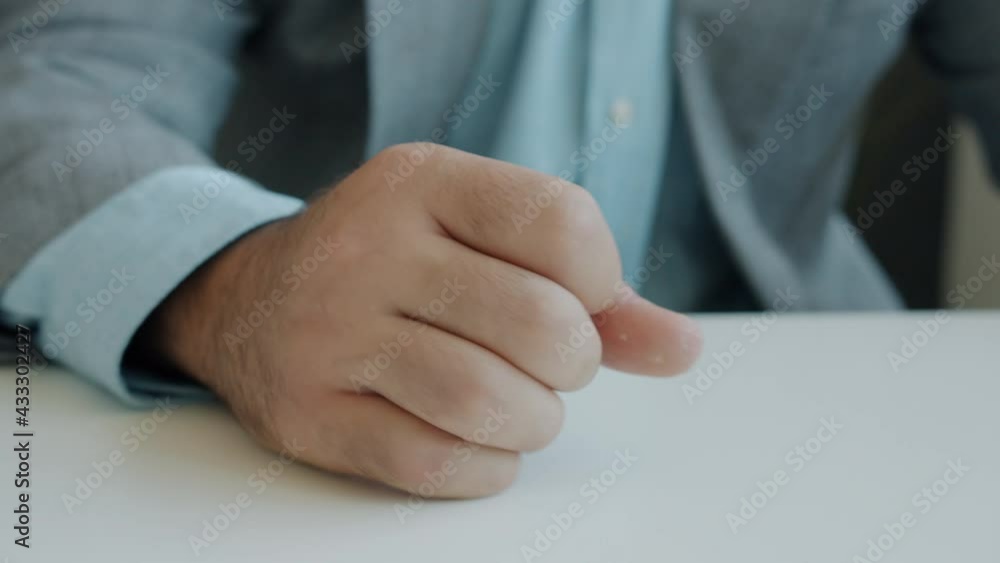 Close-up of male hand hitting table and pushing coffee cup then leaving feeling angry while businessman is expressing negative emotions in office Close-up of male hand hitting table and pushing coffee cup then leaving feeling angry while businessman is expressing negative emotions in office