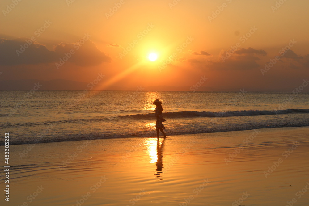 silhouette of a person running on the beach at sunset silhouette of a person running on the beach at sunset
