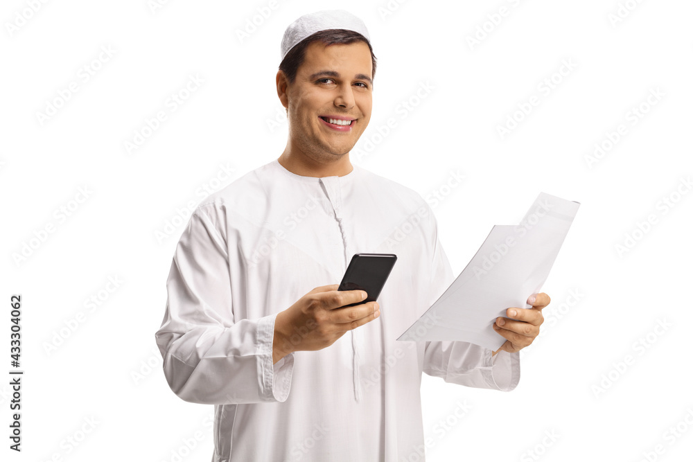 Young muslim man holding a smartphone and a paper document Young muslim man holding a smartphone and a paper document