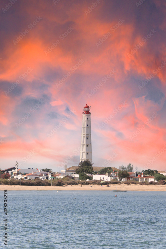 Beautiful lighthouse overlooking the ocean at sunset. Armona Island , Portugal