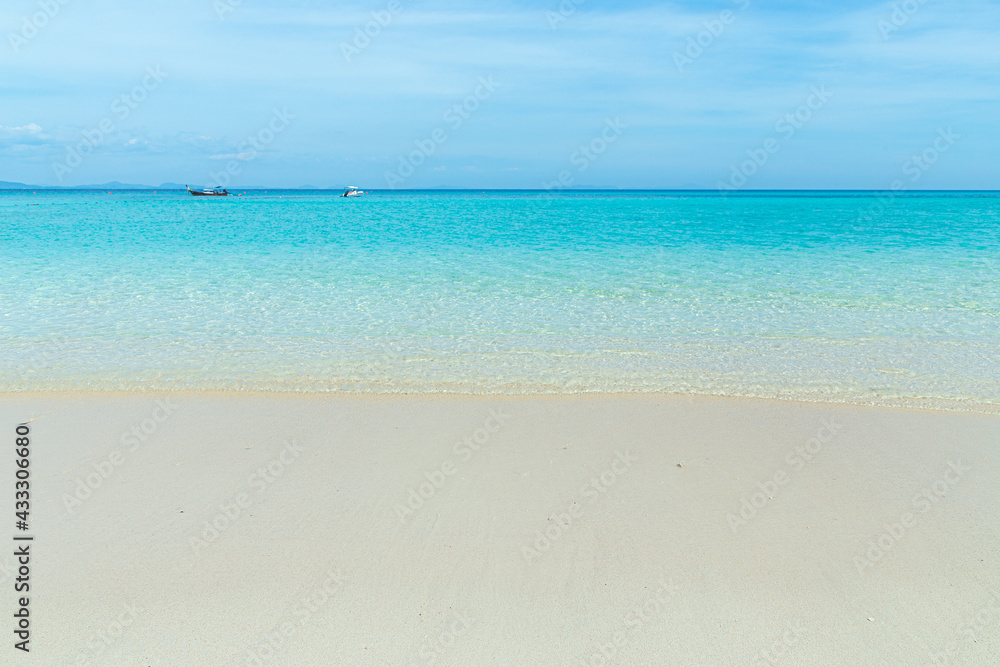 Soft blue ocean wave on clean sandy beach
