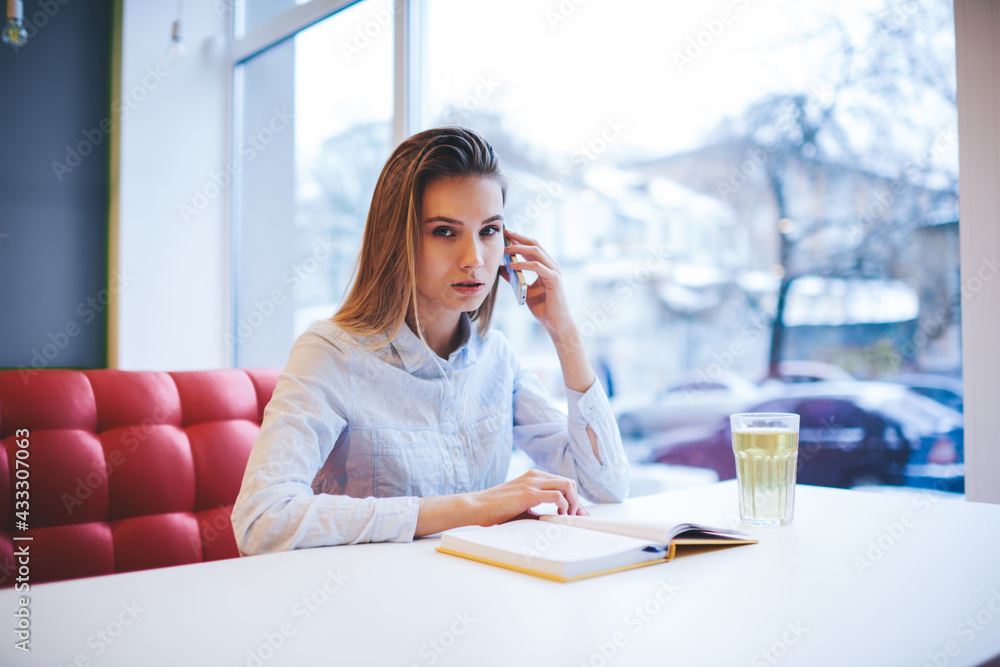 Pensive woman having conversation on smartphone Pensive woman having conversation on smartphone