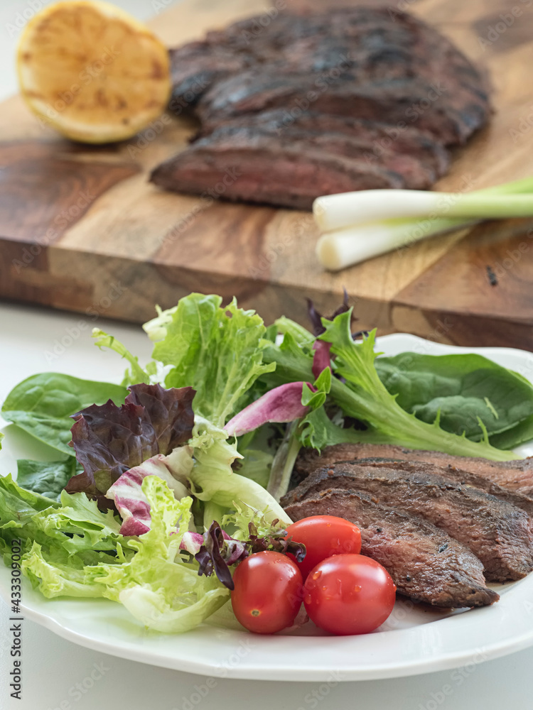 Steak Salad Plate with Steak in Background Steak Salad Plate with Steak in Background
