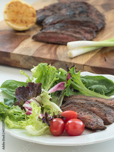Steak Salad Plate with Steak in Background