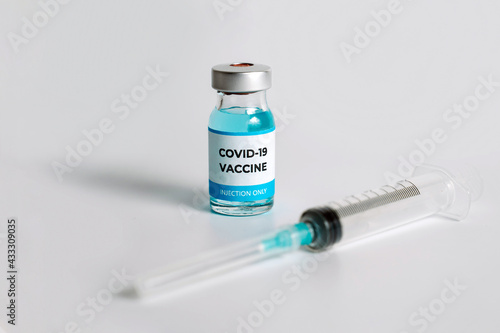 Close up of Covid-19 vaccine vial on white background. Medical vaccination concept