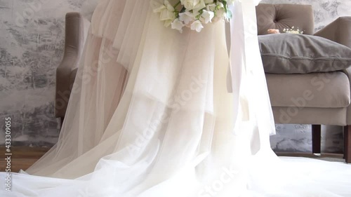 Beautiful, lovely bride in wedding luxury dress, veil. Wedding bouquet in hands 