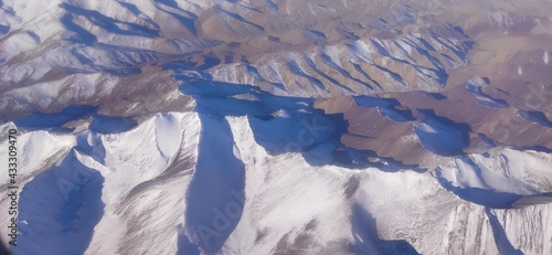 Winter mountains from the plane window photo