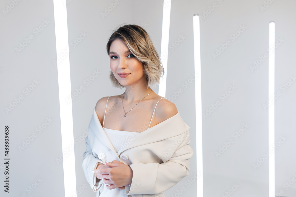 singer posing in the studio. Around the girl neon lamps singer posing in the studio. Around the girl neon lamps