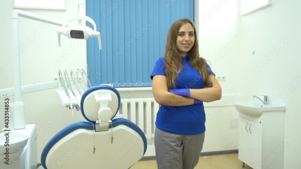 Slow Motion Young beautiful brunette female dentist at dentist's surgery Slow Motion Young beautiful brunette female dentist at dentist's surgery