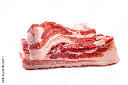 Raw pork belly meat, isolated on white background. Lard piece isolated. Fresh meat brisket photo