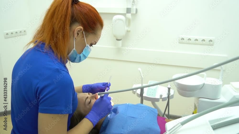 Dental cure. Molar treatment. Young female patient visiting dentist office.