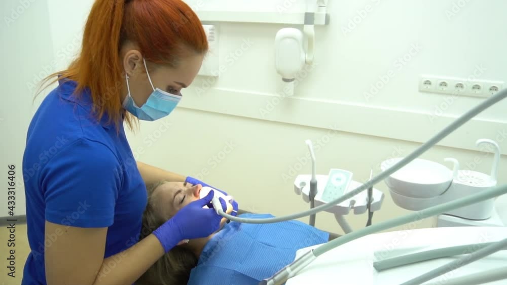 Young female dentist working in her office. Young female dentist working in her office.