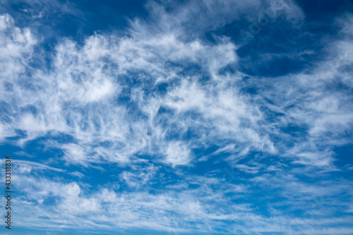 beautiful blue sky with white cirrus clouds as a natural background photo