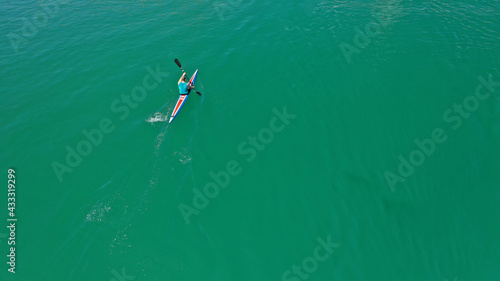 Aerial drone top down photo of young athletes competing in sport canoe in emerald lake
