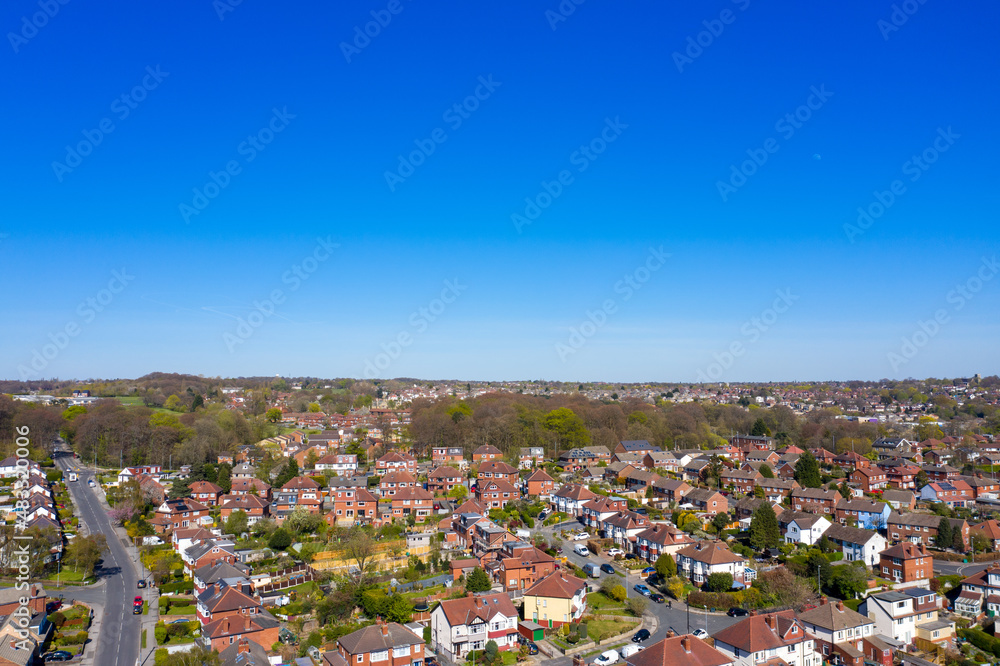 Aerial photo of the British town of Meanwood in Leeds West Yorkshire showing typical UK housing estates and rows of houses from above in the spring time on a sunny day