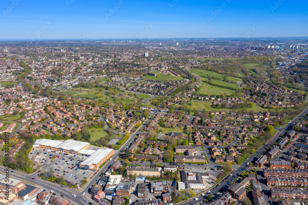 Aerial photo of the British town of Meanwood in Leeds West Yorkshire showing typical UK housing estates and rows of houses from above in the spring time on a sunny day