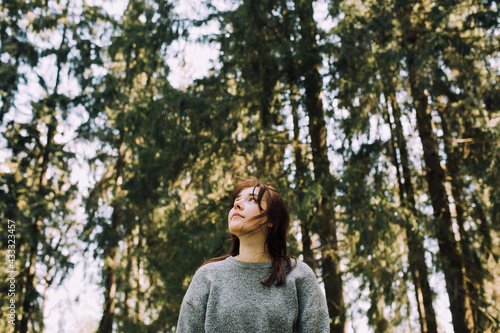 Young woman in nature. People and forest. Healthy life style. Happy walk in park. Outdoor activity casual girl lifestyle. Mind developing and maintaining positive energy. Happily Daily life