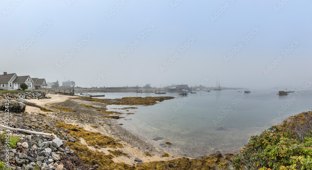 Harpswell village with beach and harbor in fog