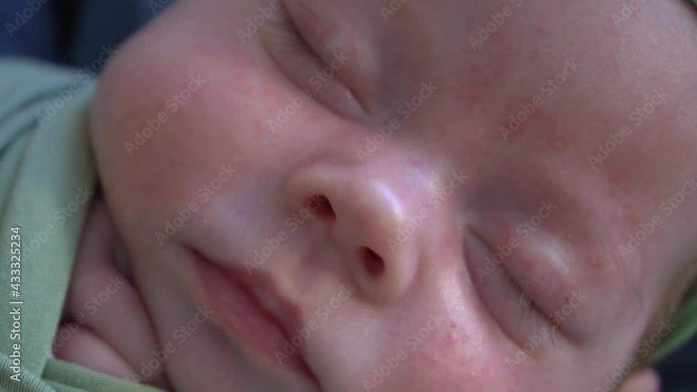 Lovely newborn baby girl sleeping on belly with a flowers bandage on his head Lovely newborn baby girl sleeping on belly with a flowers bandage on his head