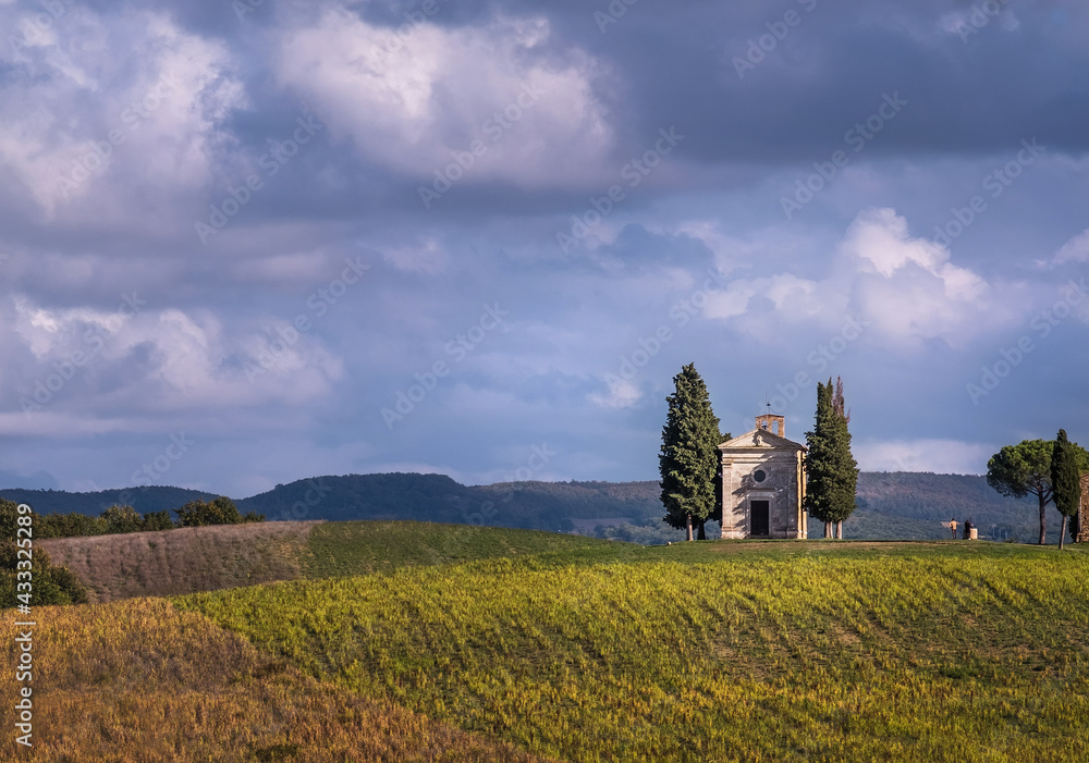 Cappella della Madonna di Vitaleta curch losted in endless Tuscany fields. Famous landmark place in Italy.