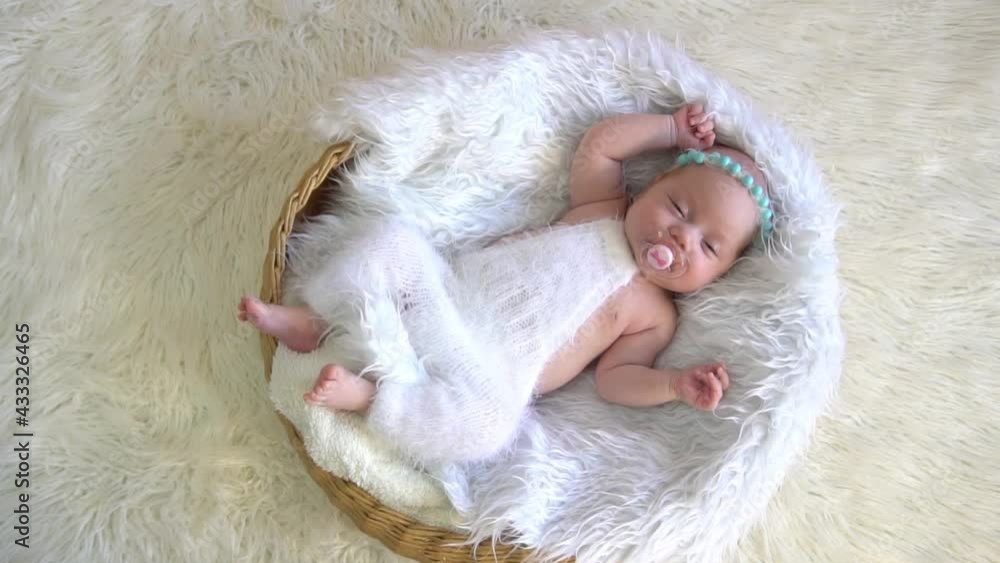 Slow Motion newborn baby girl sleeping sweetly in the basket Slow Motion newborn baby girl sleeping sweetly in the basket