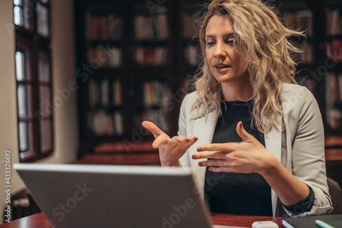 Businesswoman using a laptop for on online meeting in her office