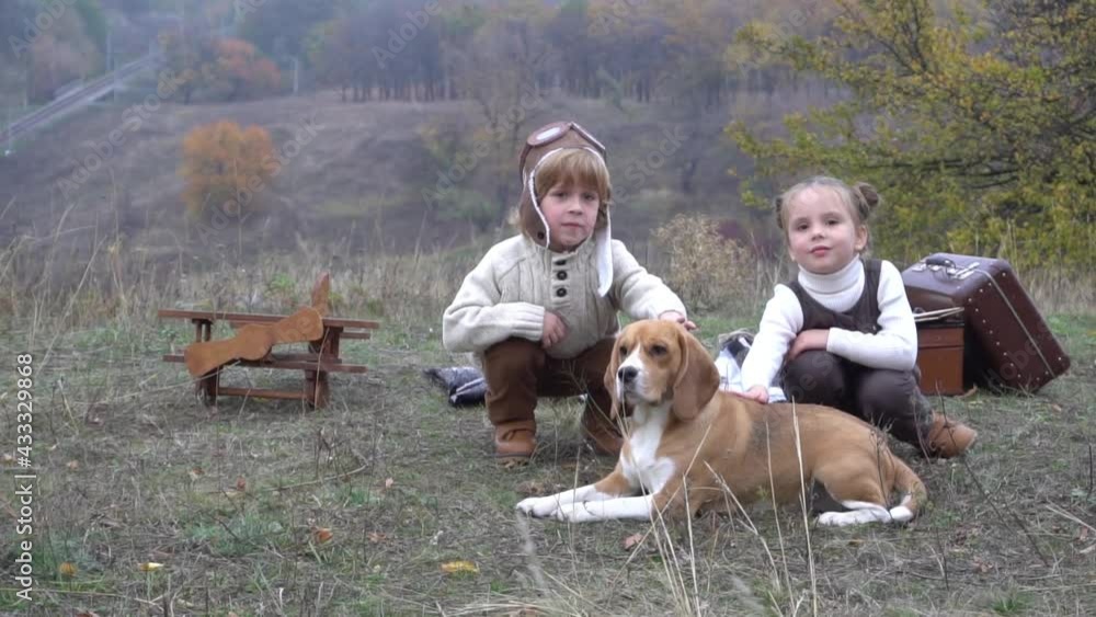 Slow Motion Kids with dog Jack Russell Terrier playing in autumn park Slow Motion Kids with dog Jack Russell Terrier playing in autumn park