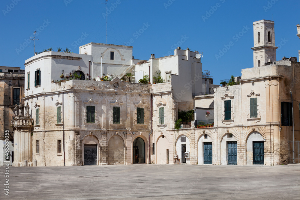 Old houses in the historic city of Lecce, Italy. White buildings in the square of the famous basilica Church of the Holy Cross (Santa Croce).