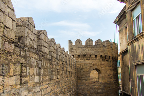 Ancient wall of old Baku. Old walls and new buildings together in Icheri sheher