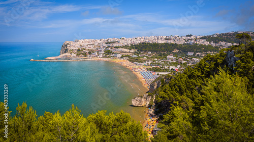 Panoramic view of Peschici with its golden beaches and rock formations, Gargano, Italy