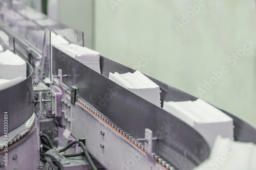 Machine for paper napkins (tissue).
A toilet paper-making machine producing toilet and bathroom paper rolls. Paper and tissue manufacturers factory and engineered machine