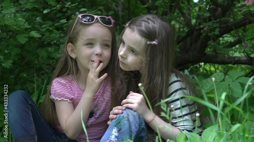 Children kid friend girls whispering ear playing smiling in a park tree outdoor