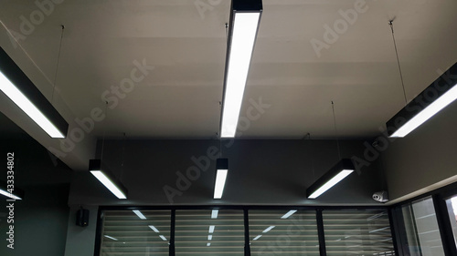 Incandescent lamp on the top of roof  Abstarct background top roof in ceiling  Darkness with light of lamp in office