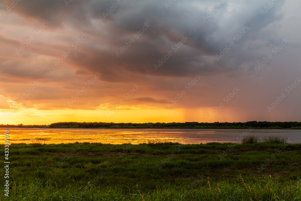 Stormy Sunset over Myakka River State Park with Beautiful Storm Clouds and Rain Falling In distance