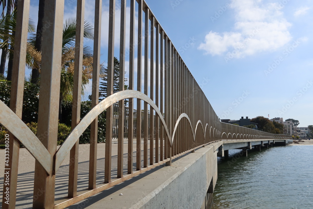 A Bridge on a City Bike and Walking Trail with Metal Supports with the bay on the Right Frame
