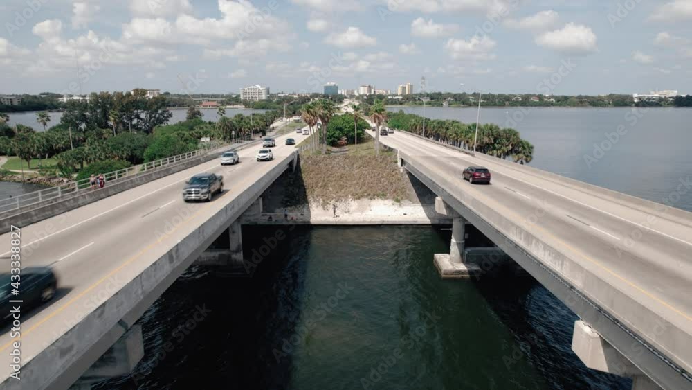 Drone shot flying parallel with traffic between two lanes of a causeway bridge. Drone shot flying parallel with traffic between two lanes of a causeway bridge.