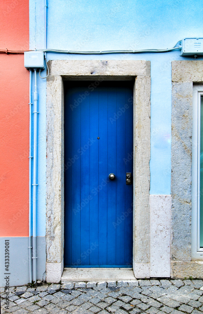 Fototapeta premium Old and colorful wooden door with iron details